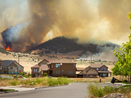 A wildfire burns near a community.