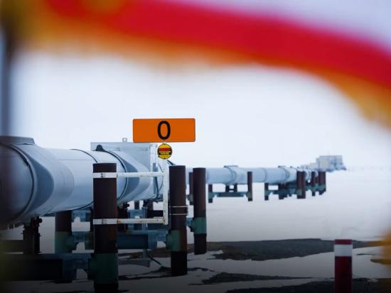 An oil pipeline snakes through snow
