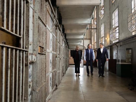 Secretary Burgum walks down prison hallway at Alcatraz. 