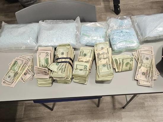 Table with seized cash and bags of pills