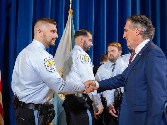 Secretary of the Interior Burgum shakes the hand of a U.S. Park Police officer.