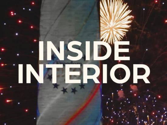 White text Inside Interior is seen over fireworks at night