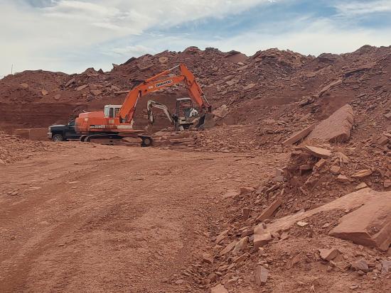 Equipment digging red dirt.