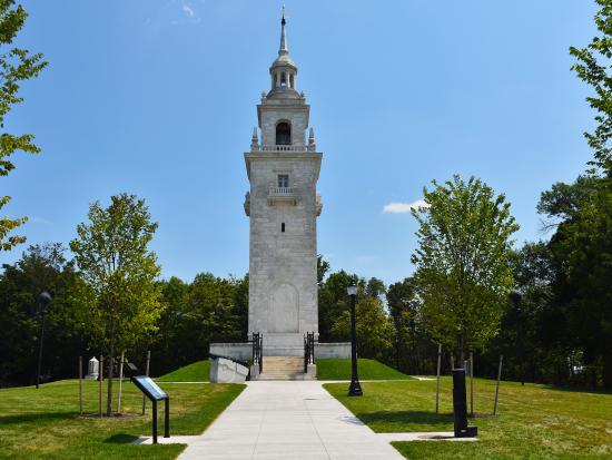 Dorchester Heights Monument, a white granite stepped tower surrounded by trees and grass