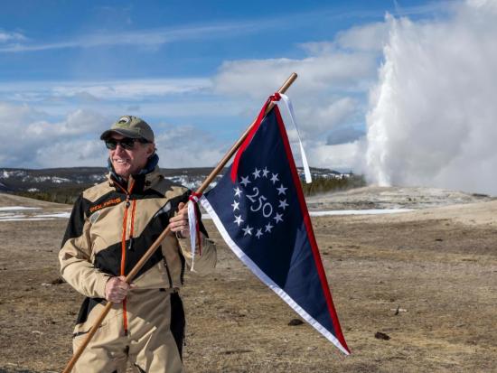 Secretary Burgum holding commemorative 250 flag