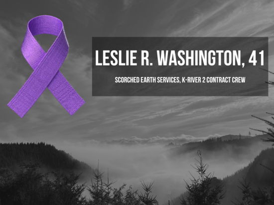 A black and white image of forested hills with low-lying smoke. A graphic of a purple ribbon appears in the sky next to the text "Leslie R. Washington, 41, Scorched Earth Services, K-River 2 Contract Crew"