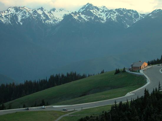 A view of the Hurricane Ridge Day Lodge from above, with the Olympic Mountains in the background