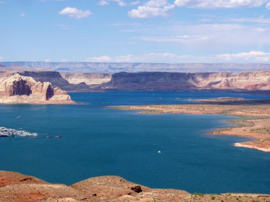 A view of a large blue reservoir surrounded by red rock formations