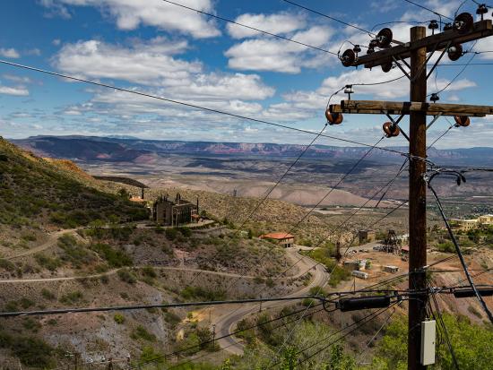 Buildings nestled in mountains in Arizona with power lines in the foreground