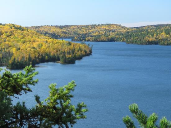 An aerial view of a bluff overlooking autumn trees and lake water in the Boundary Waters Canoe Area Wilderness
