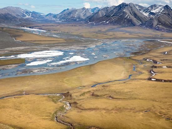 The Canning River flows north from the Brooks Range across the coastal plain into the Beaufort Sea.