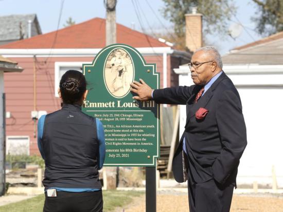 Secretary Deb Haaland standing in front of Emmett Louis Till sign in front of church.