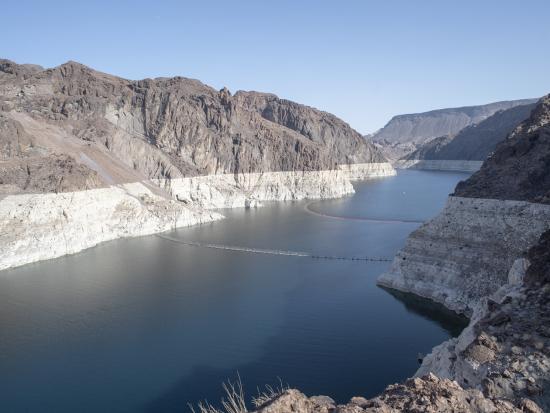 Wide river running between two steep gray cliffs. 
