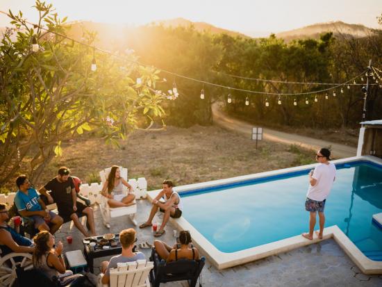 Picture of friends socializing next to a swimming pool