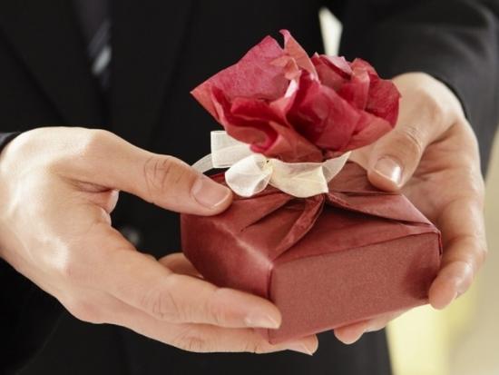 Hands with wrapped gift