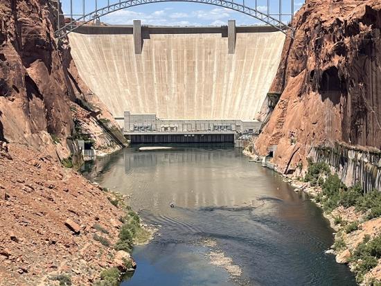 Dam surrounded by rock cliffs.