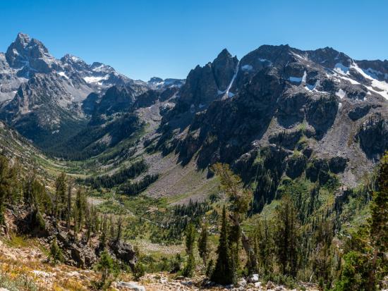 Rocky canyon area surrounded by steep mountain range.