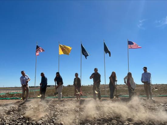 8 people with shovels participating in groundbreaking. 