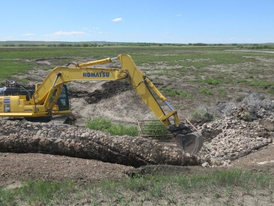 Heavy equipment is being used to dig up the ground. 