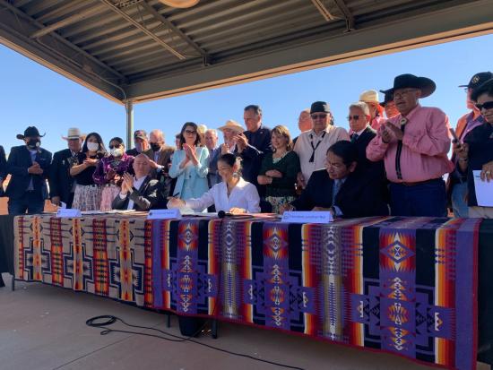 A view of Secretary Haaland celebrating progress with government officials and members of Tribal communities