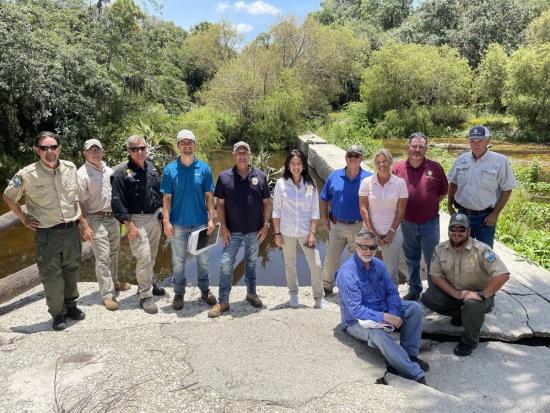 Assistant Secretary Estenoz standing with members of the Myakka River Down’s Dam Removal Project in front of a fish passage