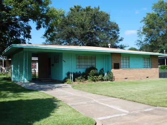 Evers House is a green single-story house with brick accents.