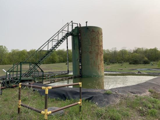 Orphaned well surrounded by grassy field in Michigan