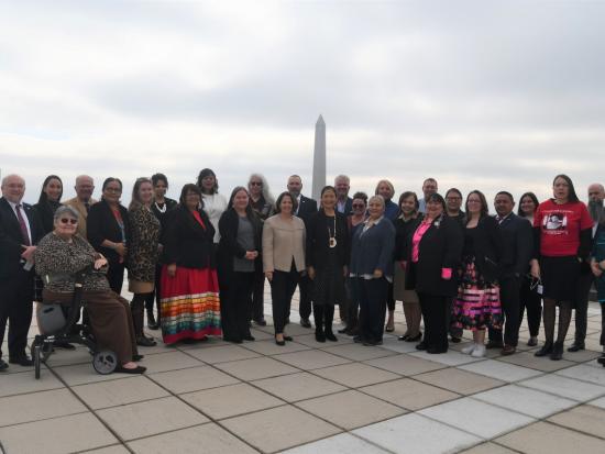 Secretary Haaland takes a picture with members of the Not Invisible Act Commission