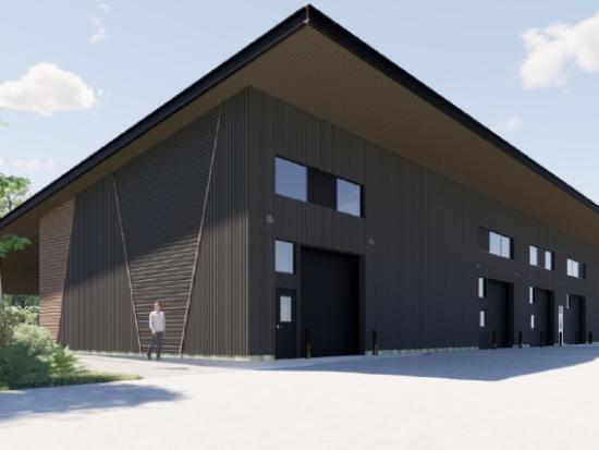 Design drawing of facility with brown siding, slanted rooftop, and large garage openings