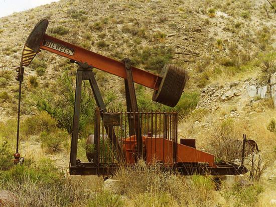 An abandoned well with rusted pumpjack