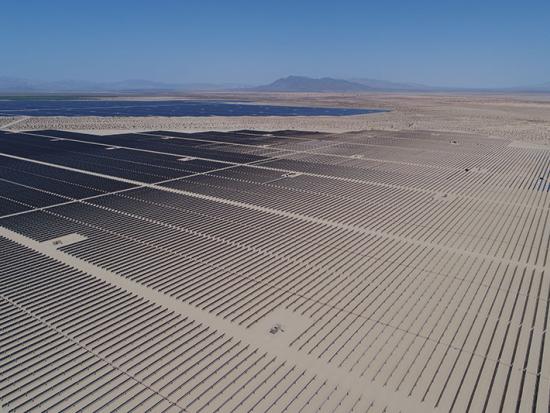 Photovoltaic facility in California with mountains in the distance