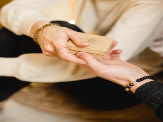 Two hands exchanging a gift