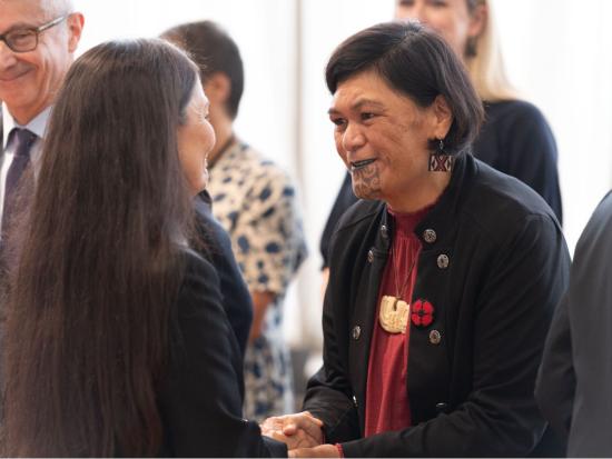Secretary Haaland and Minister Mahuta greet each other during pōwhiri in New Zealand