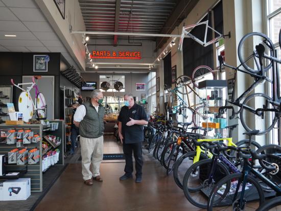 Secretary Bernhardt talks to a man in a bicycle shop.