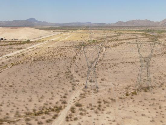 mountain desert landscape showing overhead power lines. 