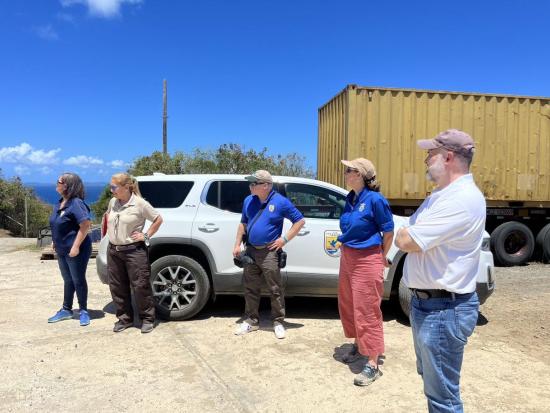 A group of people wearing USFWS shirts under a clear blue sky