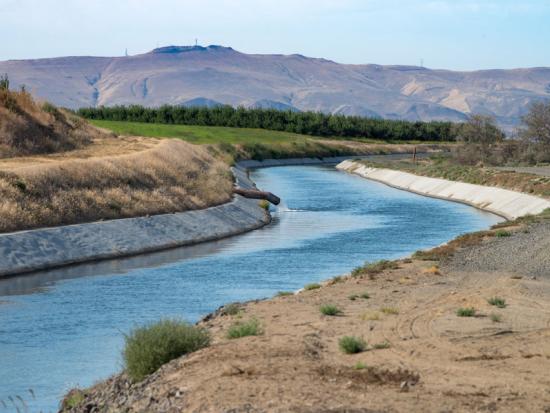 Western canal surrounded by high desert landscape. 