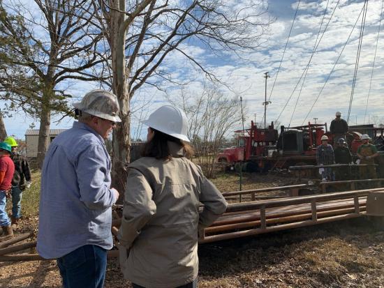 A view of laborers working to plug an orphaned oil and gas well