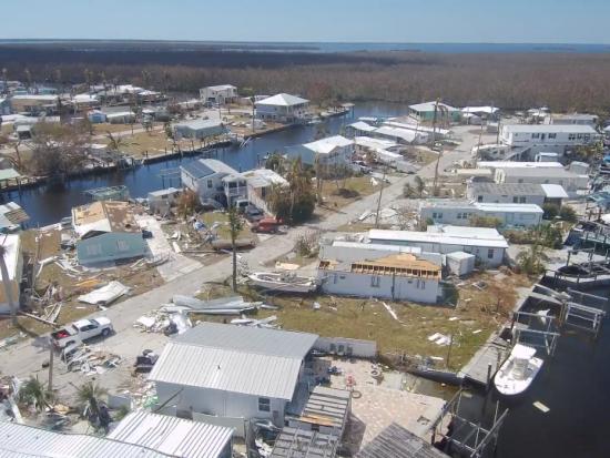 Aerial view of shattered houses and flooded property 