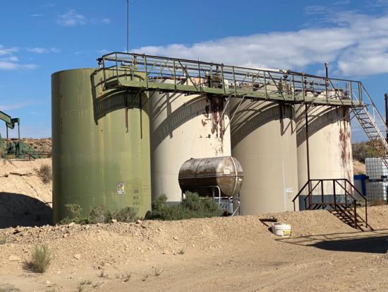 Rusting storage tanks at the site of an abandoned oil well in New Mexico