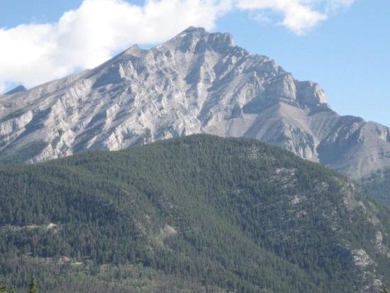 A mountainous landscape against a blue sky 