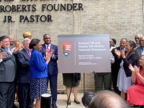 Secretary Haaland stands and applauds as a Till Monument sign is unveiled 