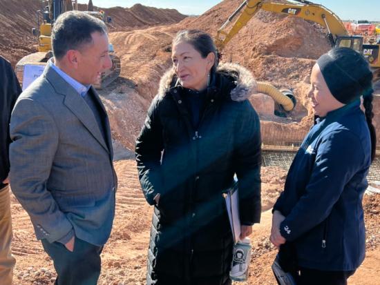 Secretary Haaland speaks with a local official at the site of a New Mexico water project