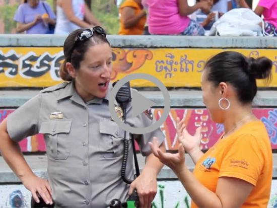 A National Park Service ranger speaks to a member of the public at a community event 