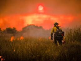 A firefighter works on a prescribed fire at sunset in southern Florida. Photo by NPS.