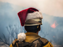Wildland firefighter with a Santa hat on the Thomas Creek Fire. Photo by Stuart Palley, FS.