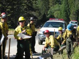 Firefighters gathered on a roadside for a briefing in Yosemite National Park