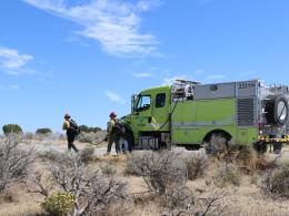 Two firefighters near wildfire response truck