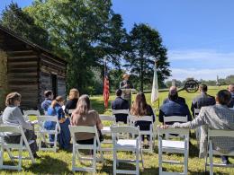 Superintended Brad Bennett providing remarks to a crowd seated in front of the re-created Brotherton Cabin in Chickamauga Battlefield