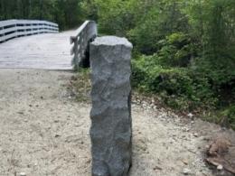 Stone monument next to bridge.